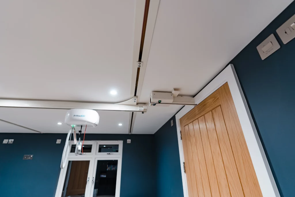 H-Frame hoist joining through a door into another track